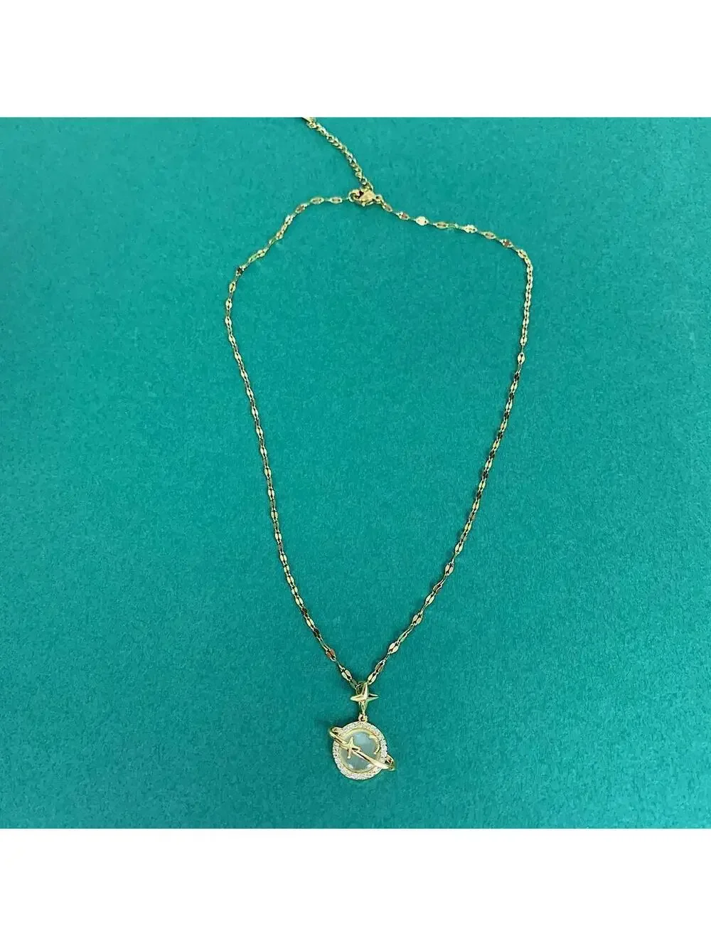 Cyber Y2k 2000s style gold opal planet pendant opium necklace. Cool design.